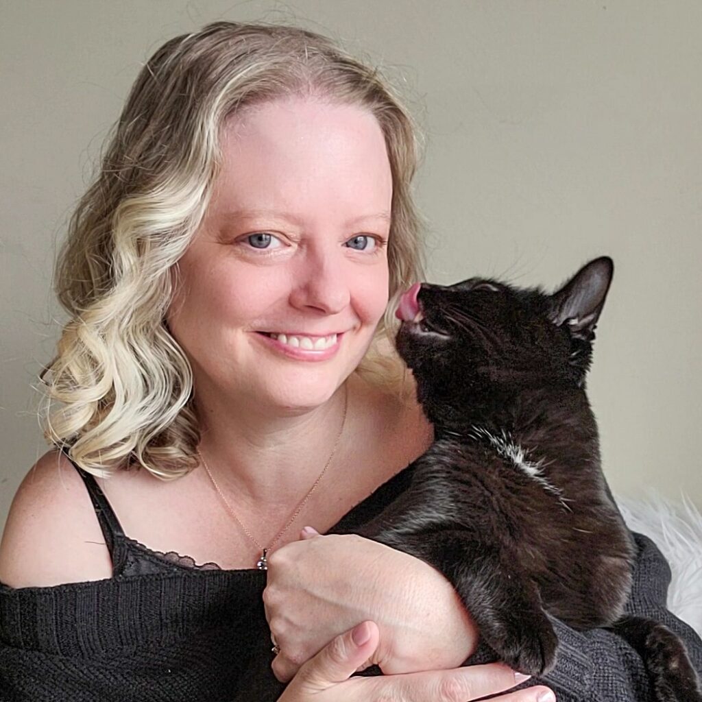 Black cat slow blinking with golden eyes as a sign of cat love